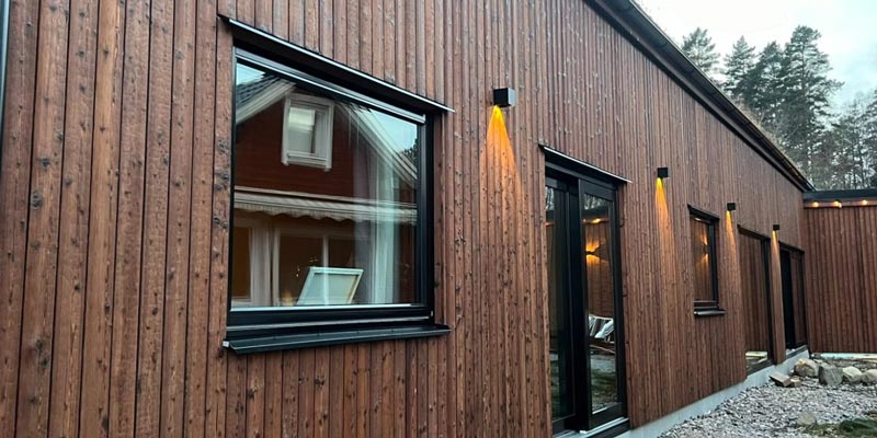Träfasad på ett hus med svarta detaljer